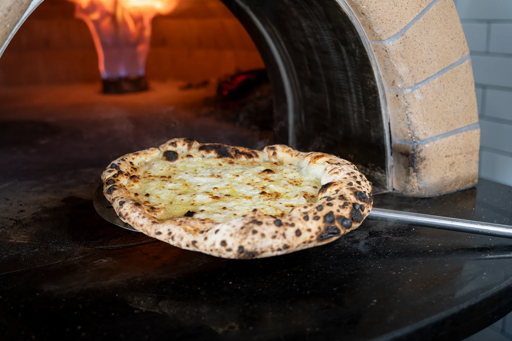 Wood-fired pizza oven at El Fornino