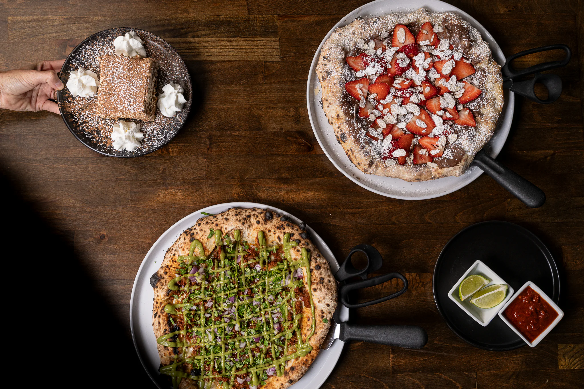 Several pizzas on a table for display
